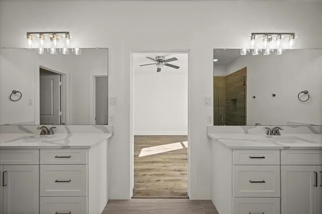 a bathroom with a sink double vanity and a mirror