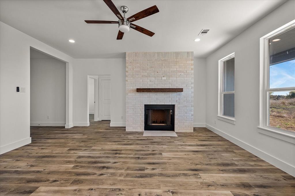 3232 Willow Road Celeste, TX 75423 - Photo 6 of 31 a view of empty room with wooden floor and fireplace