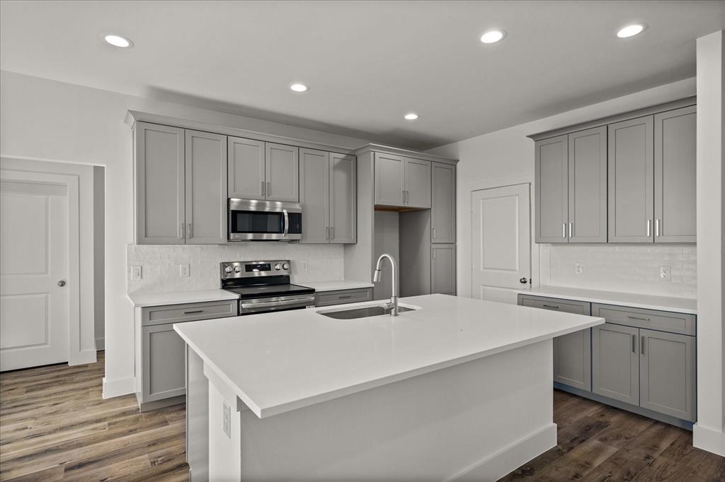 3232 Willow Road Celeste, TX 75423 - Photo 9 of 31 a kitchen with a sink a stove a refrigerator and cabinets