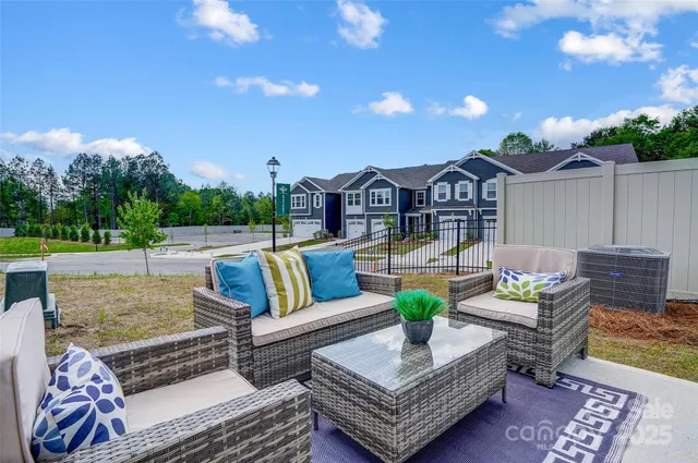 a view of a patio with couches and a table and chairs with wooden floor