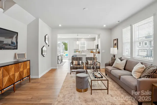 a living room with furniture wooden floor and a flat screen tv