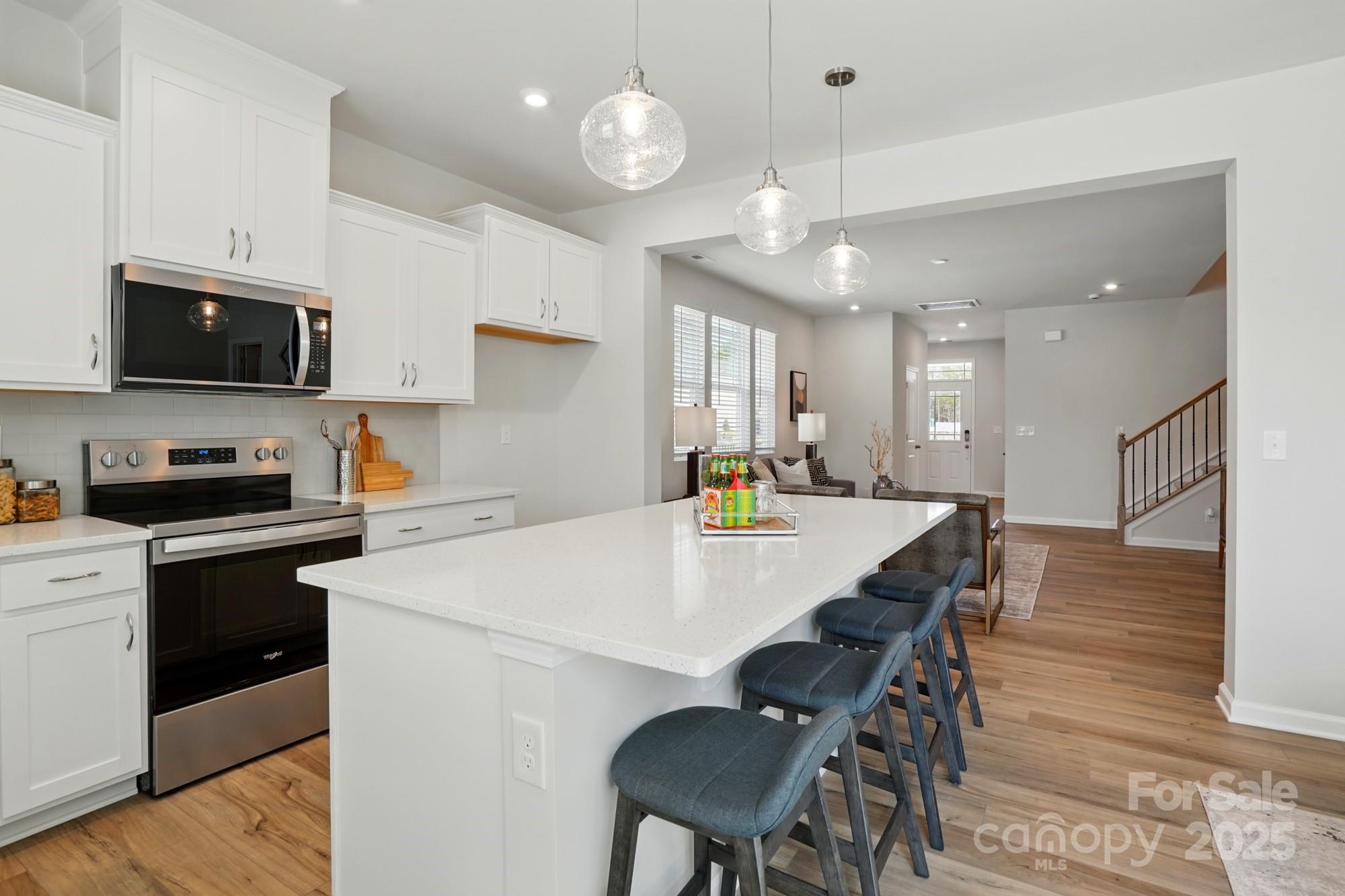 331 Laura Elizabeth Lane Clover, SC 29710 - Photo 8 of 31 a kitchen with a dining table chairs microwave and cabinets