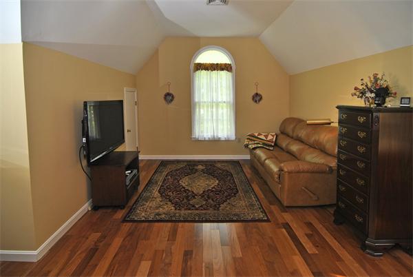 34 Grey Rock Road Bedford, NH 03110 - Photo 15 of 27 a living room with furniture and a flat screen tv