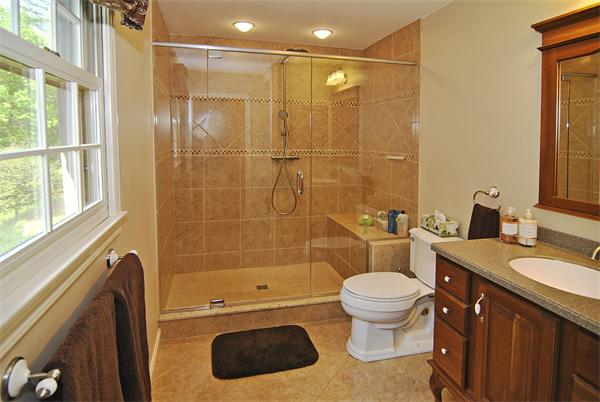 34 Grey Rock Road Bedford, NH 03110 - Photo 16 of 27 a bathroom with a sink a toilet and shower