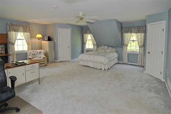 34 Grey Rock Road Bedford, NH 03110 - Photo 19 of 27 a spacious bedroom with a bed a couch and large windows