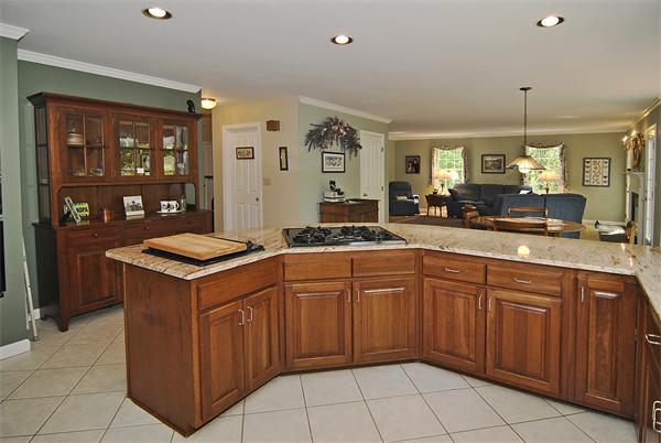 34 Grey Rock Road Bedford, NH 03110 - Photo 9 of 27 a kitchen that has a sink and a stove in it
