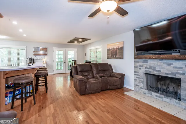 a living room with furniture a flat screen tv and a fireplace