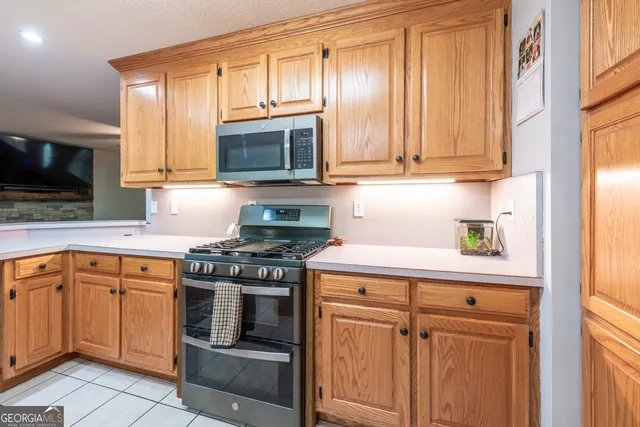 a kitchen with white cabinets and appliances