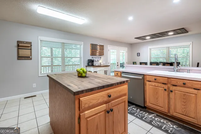 a kitchen with cabinets appliances a sink and a window