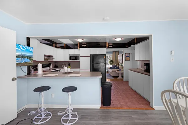 a kitchen with furniture and a wooden floor