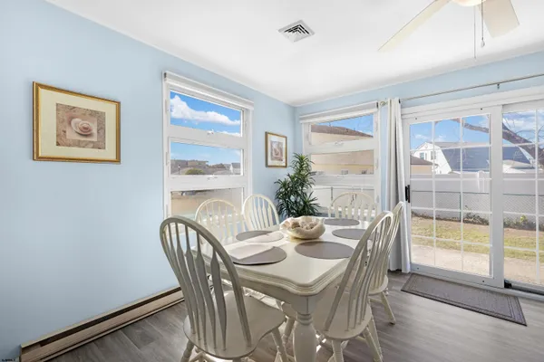 a dining room with furniture window and wooden floor