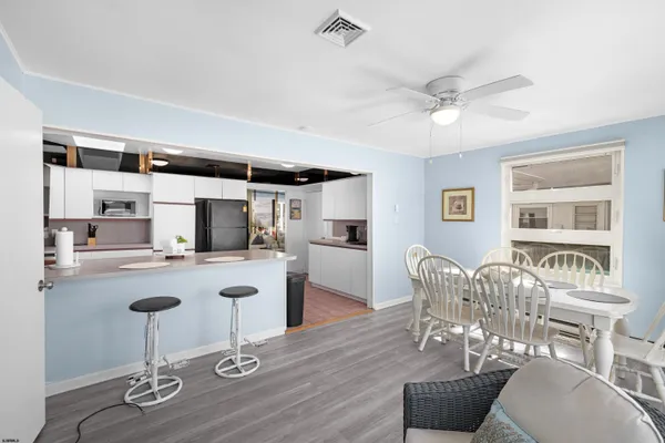 a kitchen with stainless steel appliances granite countertop a microwave a stove and white cabinets
