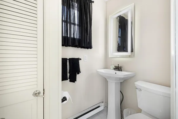 a bathroom with a sink and mirror with toilet