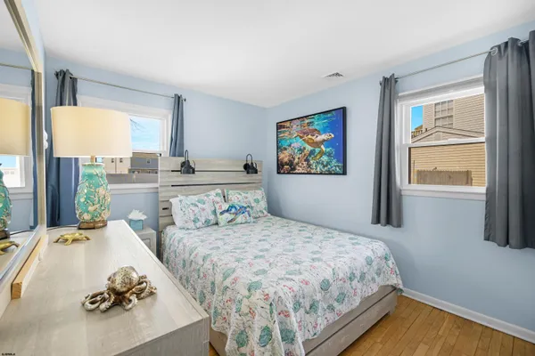 a bedroom with a bed and glass door
