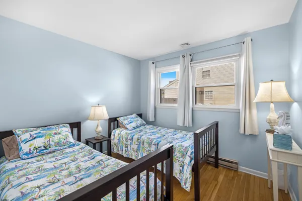 a bedroom with two beds and a table
