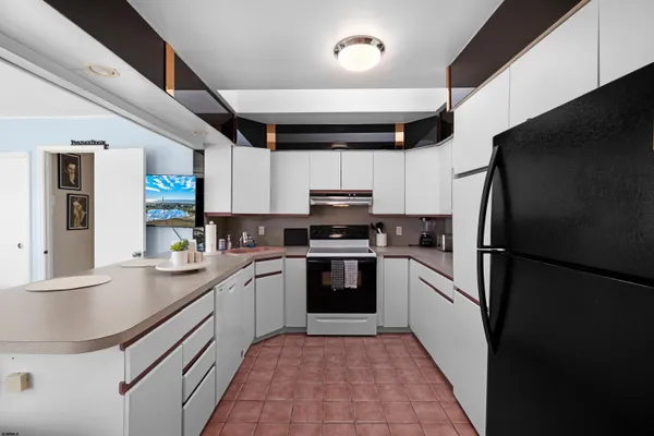 a kitchen with a sink stainless steel appliances and cabinets