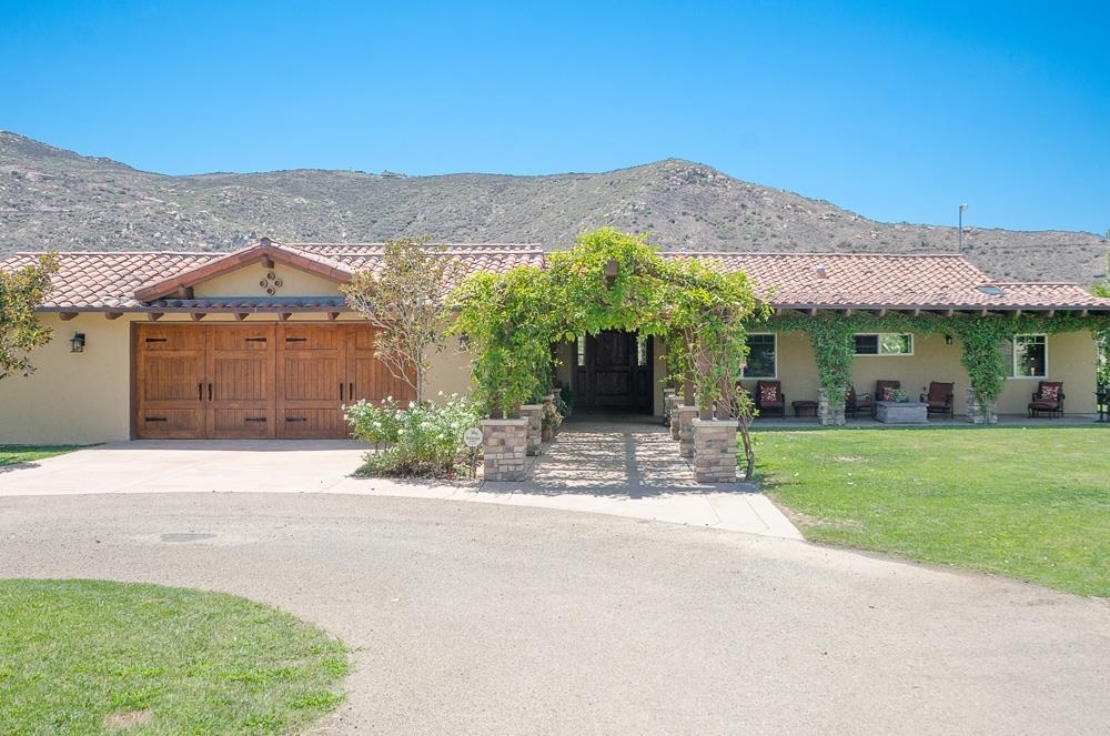 18101 Old Coach Road Poway, CA 92064 - Photo 1 of 25 Front of the home with arbor and circular driveway.