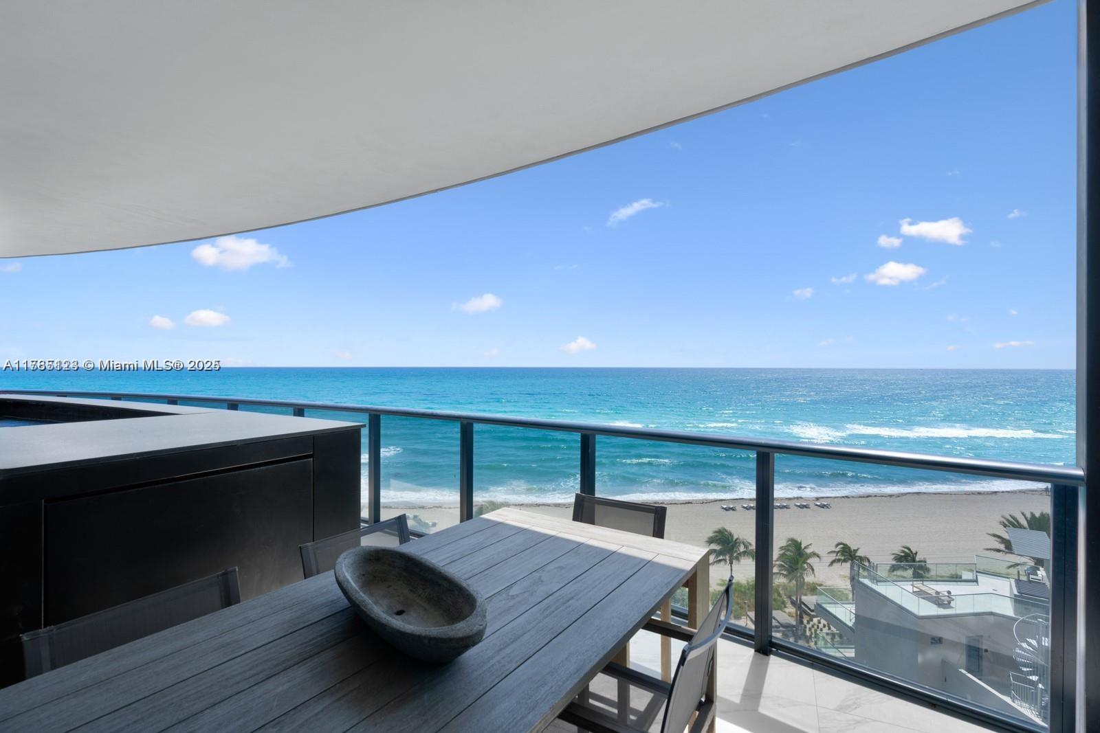 18555 Collins Avenue, Unit 701 Sunny Isles Beach, FL 33160 - Photo 1 of 21 a view of a livingroom with furniture and wooden floor