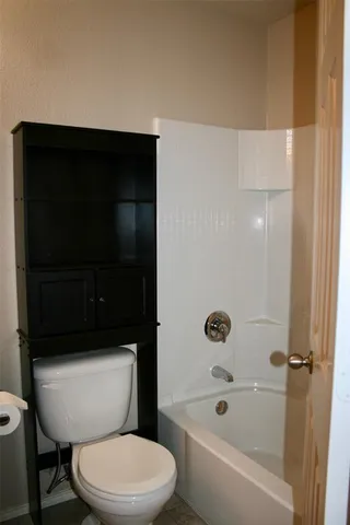 a bathroom with a toilet a sink and bathtub