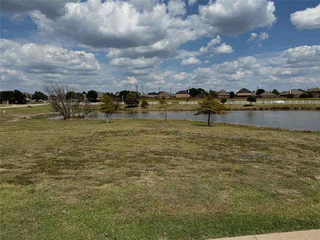 a view of a lake with houses in the back