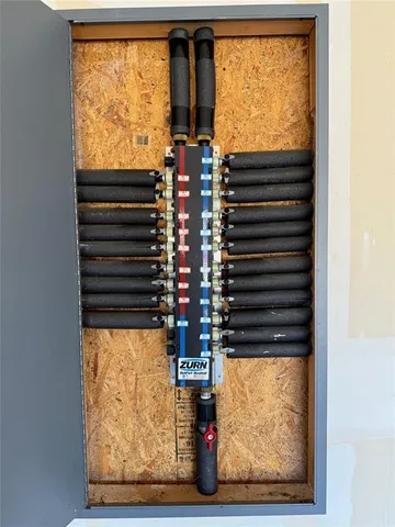 a view of a brick house with many windows and plants