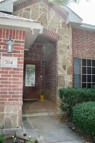 a front view of a building with potted plants