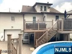 a view of a house with wooden deck