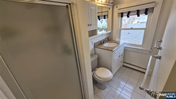 a white toilet sitting in front of a bathroom