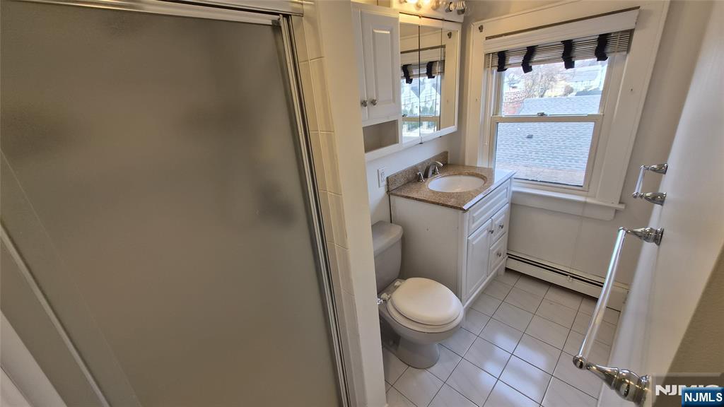 6 Chamberlain Avenue Little Ferry, NJ 07643 - Photo 7 of 25 a white toilet sitting in front of a bathroom