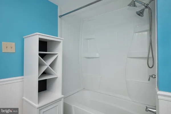 a bathroom with a bathtub and dryer