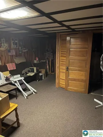 a room with pool table and chairs