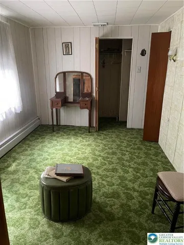 a view of a room with a window and furniture