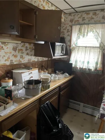 a view of a porch with a floor to ceiling window next to a yard