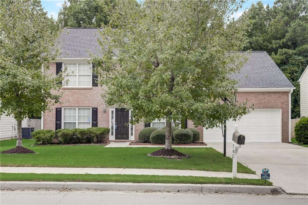 a front view of a house with a yard and garage