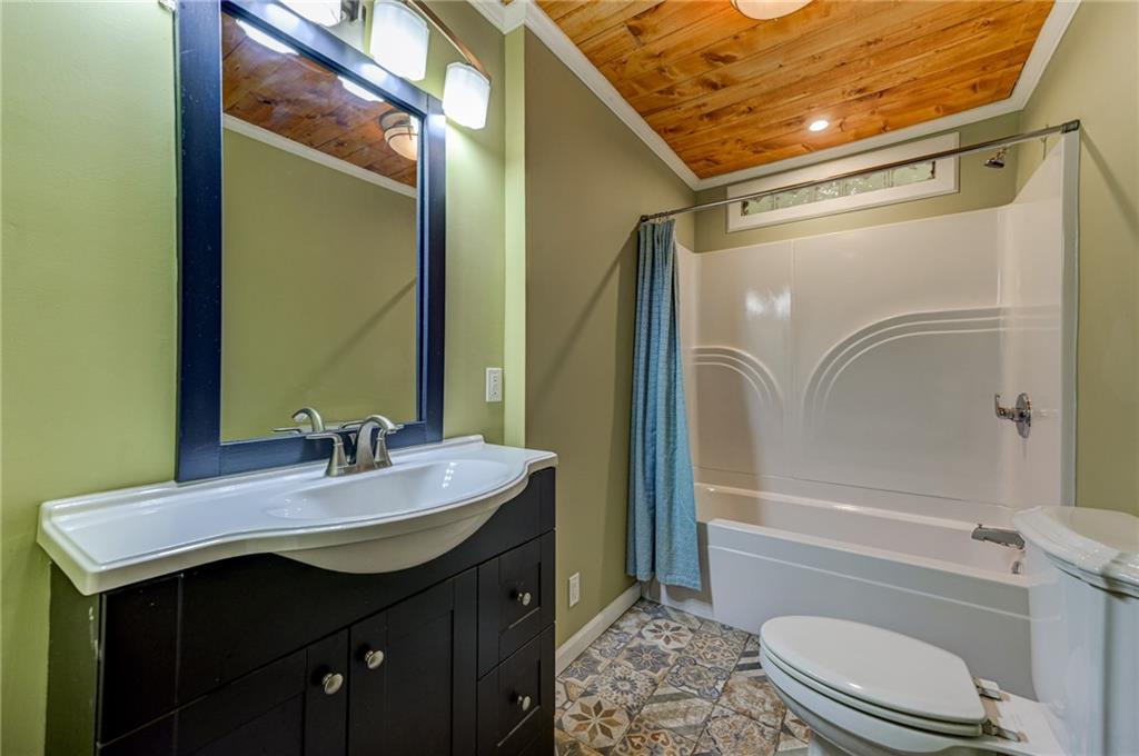 4100 Adrian Street Tucker, GA 30084 - Photo 16 of 23 a bathroom with a sink a toilet and tub