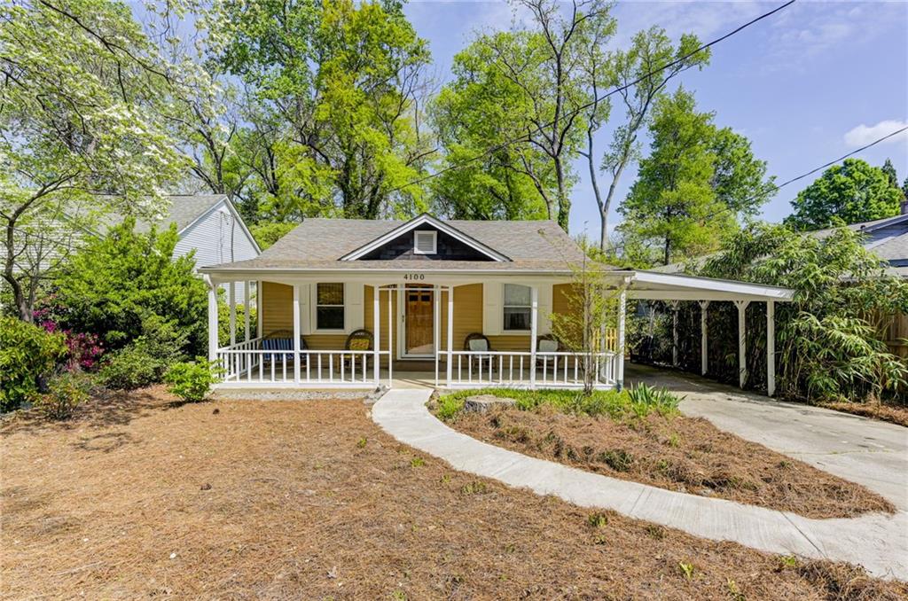 4100 Adrian Street Tucker, GA 30084 - Photo 2 of 23 a front view of a house with a yard table and chairs