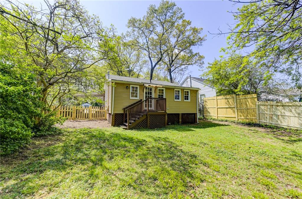 4100 Adrian Street Tucker, GA 30084 - Photo 21 of 23 a view of a house with a big yard and large tree