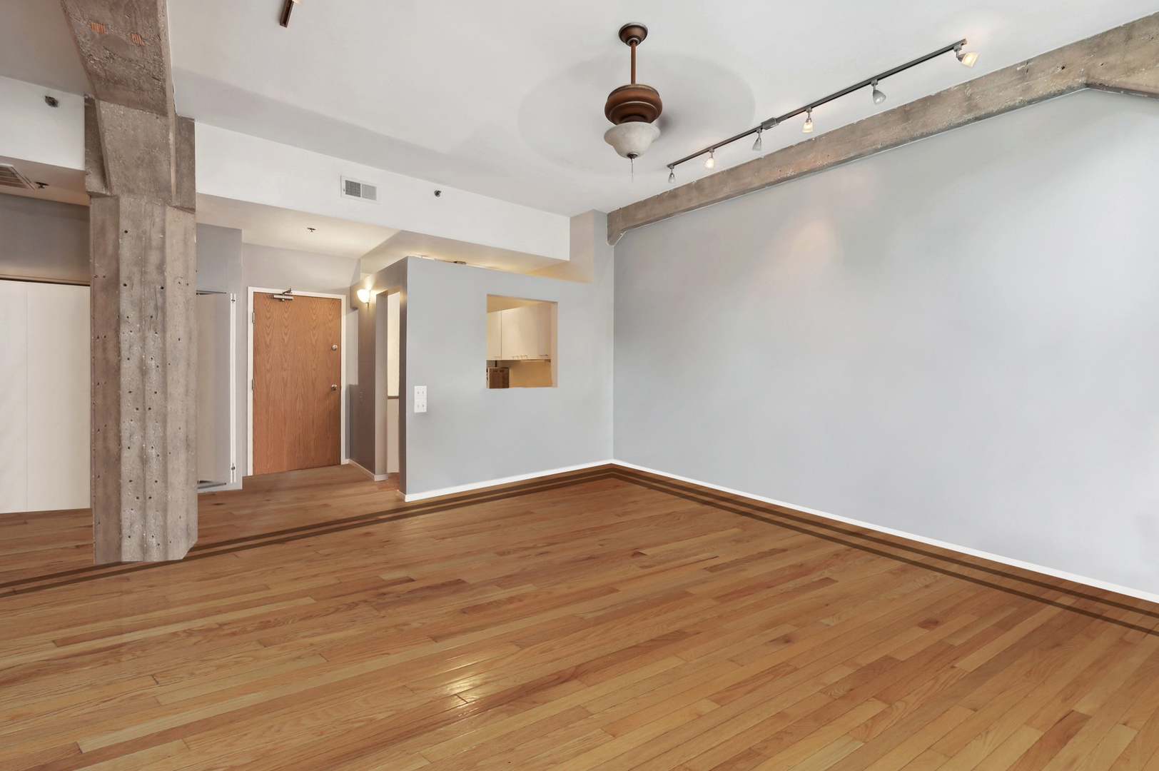 720 South Dearborn Street, Unit 305 Chicago, IL 60605 - Photo 14 of 20 a view of an empty room with wooden floor and a window