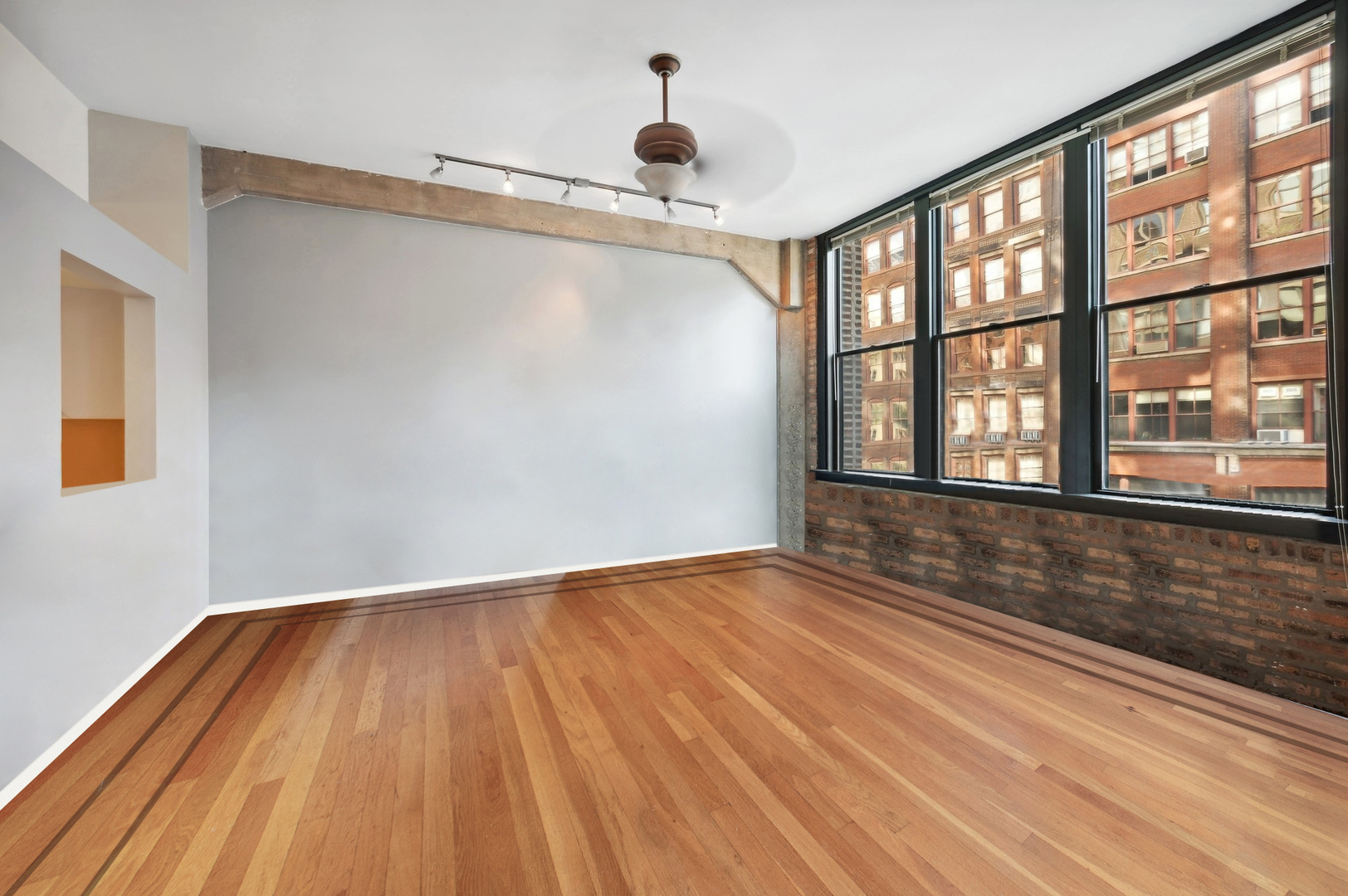 720 South Dearborn Street, Unit 305 Chicago, IL 60605 - Photo 10 of 20 a view of empty room with wooden floor and fan