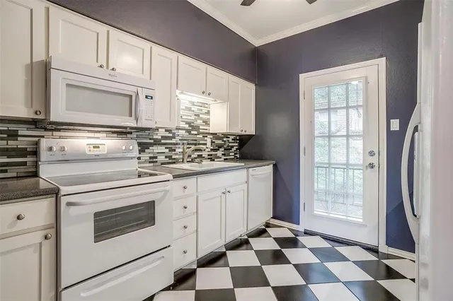 a kitchen with stainless steel appliances a stove a sink and a refrigerator