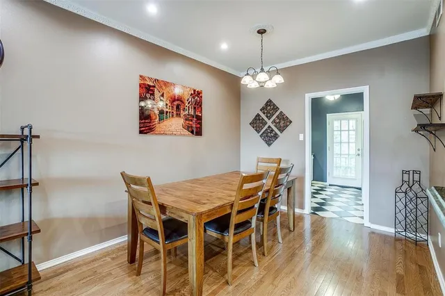 a view of a dining room with furniture wooden floor and chandelier