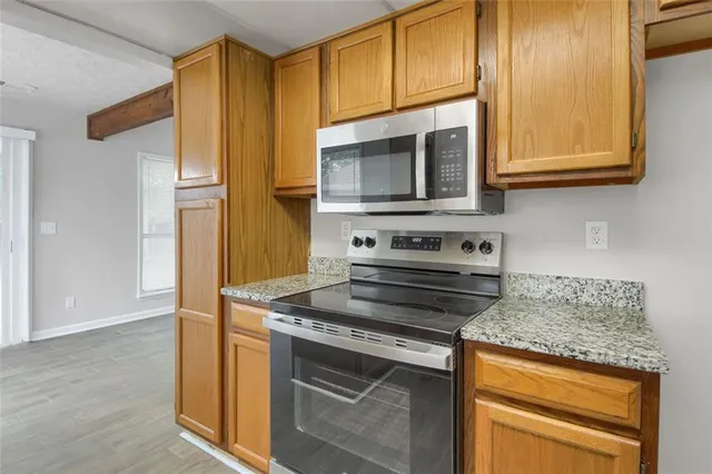 a kitchen with granite countertop a sink and a window
