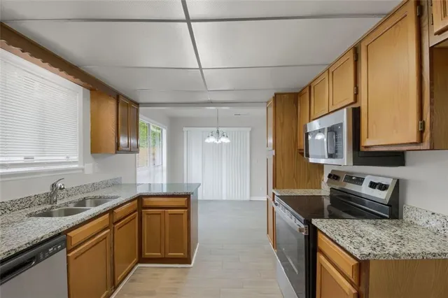 a kitchen with kitchen island granite countertop counter top space and stainless steel appliances