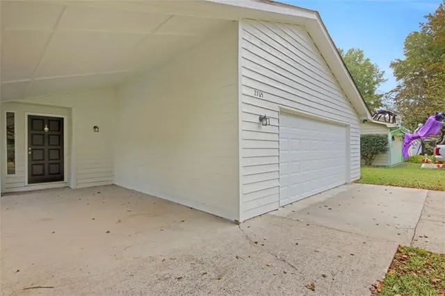 a view of a house with a yard and garage