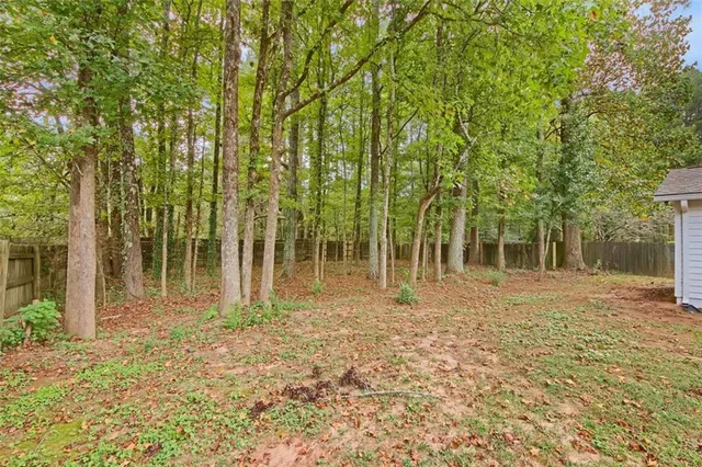 a view of a hallway with a fireplace and cabinet