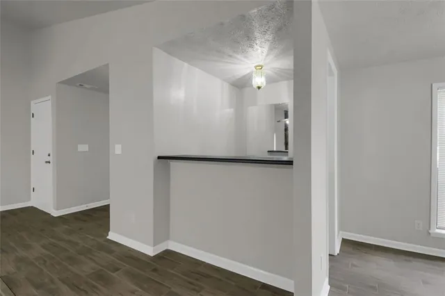 a view of a room with window wooden floor and brick wall