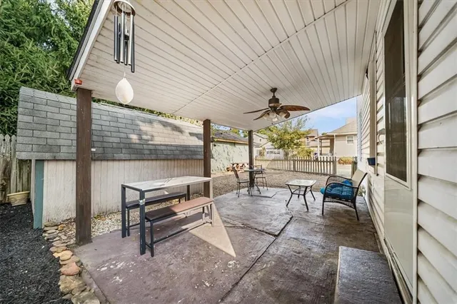 a view of a patio with a table and chairs under an umbrella