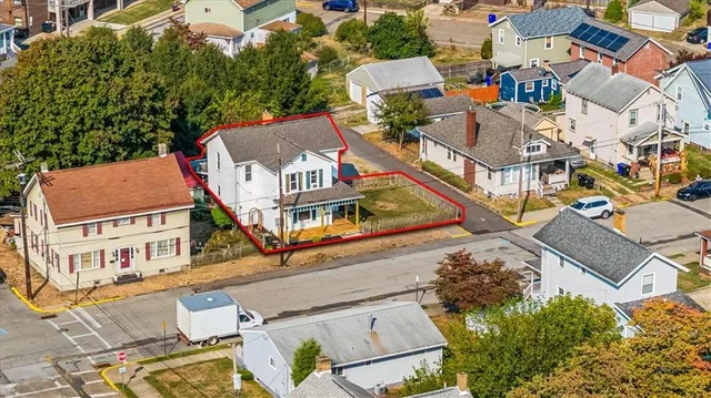 an aerial view of residential houses with outdoor space