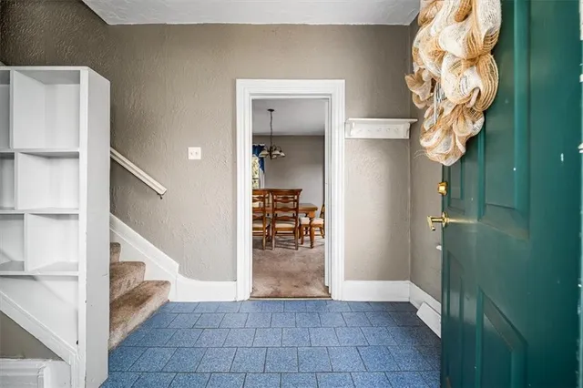 a view of entryway and hall with wooden floor