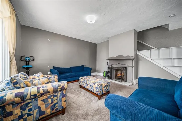 a bedroom with furniture and a fireplace